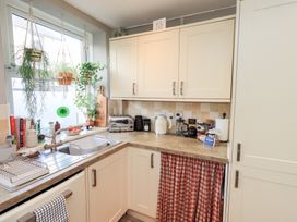 A kitchen with a sink and appliances at Gosling Cottage in Kendal