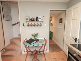 A kitchen with a table and chairs at Gosling Cottage in Kendal