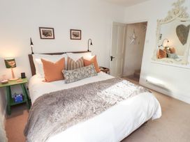 A bedroom featuring a bed and a bedside table at Gosling Cottage Kendal