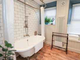 A bathroom with a bathtub and shower at Gosling Cottage in Kendal