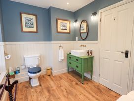 A bathroom with a toilet and wash basin at Gosling Cottage in Kendal
