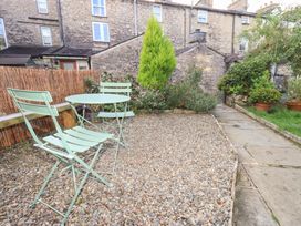 A garden with a table and chairs at Gosling Cottage in Kendal