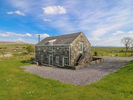 A house with stone exterior and gravel area at Bwthyn Derwin Fawr in Garndolbenmaen near Penygroes