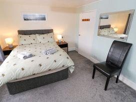 A bedroom with a bed and bedside tables at The Golden Cross Cottage in Evesham