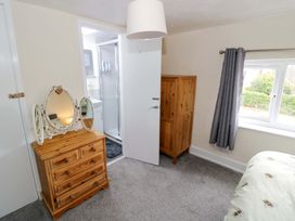 A bedroom with a dressing table and wardrobe at The Golden Cross Cottage in Evesham