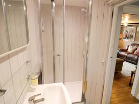 A bathroom with a shower and sink at The Golden Cross Cottage Evesham