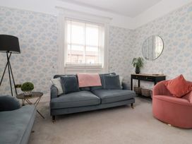 A living room with a sofa and armchair at The Grange in Flamborough