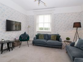 A living room with a sofa and television at The Grange in Flamborough