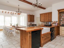 A kitchen with a wooden island and appliances at The Grange in Flamborough