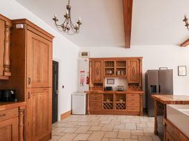 A kitchen with wooden cabinets and appliances at The Grange in Flamborough