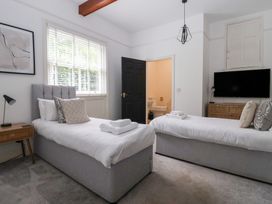 A bedroom with two beds and a tv at The Grange in Flamborough