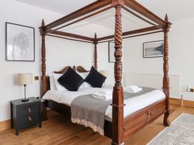 A bedroom with a four-poster bed and bedside table at The Grange in Flamborough
