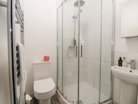 A bathroom with a shower, toilet, and sink at The Grange in Flamborough