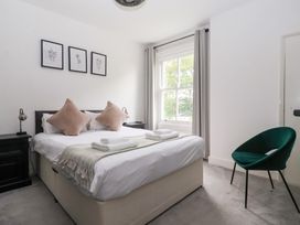 A bedroom with a bed, chair, and window at The Grange in Flamborough