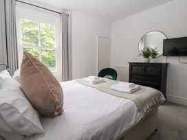 A bedroom with a bed and a dresser at The Grange in Flamborough