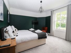 A bedroom with a bed and a chair at The Grange in Flamborough