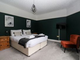 A bedroom with a bed and bedside table at The Grange in Flamborough