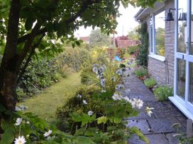 A garden pathway with plants and flowers at Woodstock in Chard