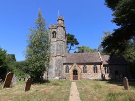 A church with a graveyard and pathway at Woodstock in Chard