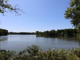 A lake surrounded by trees at Woodstock in Chard