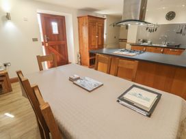 A dining room with a table and chairs at Ash Barn in Falmouth
