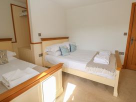 A bedroom with two beds and towels at Ash Barn in Falmouth