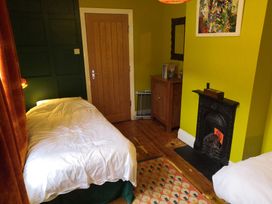 A bedroom with two beds and a fireplace at 33 High Street Fortuneswell