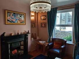 A living room with a fireplace and a sofa at 33 High Street in Fortuneswell