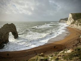 A beach with a rock formation and people walking at Agua de Plata, 16 Wakeling Island, Silverlake Dorchester