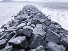 A rocky jetty extending into the water at Agua de Plata, 16 Wakeling Island, Silverlake Dorchester