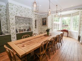 A dining room with a large wooden table and chairs at Syleham House in Syleham near Eye