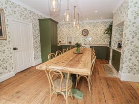 A kitchen with a wooden dining table and chairs at Syleham House Syleham near Eye
