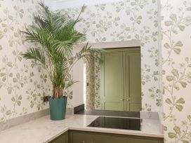 A kitchen with a palm plant on a marble countertop at Syleham House Syleham near Eye