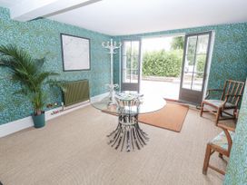 A snug with a table and chairs at Syleham House in Syleham near Eye