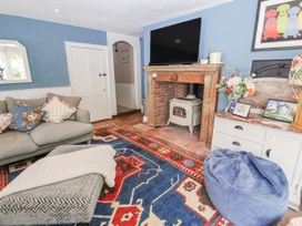 A living room with a fireplace and sofa at Syleham House in Syleham near Eye