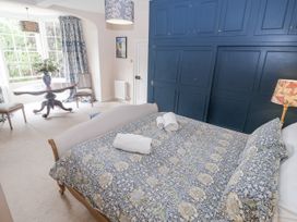 A bedroom with a bed and a small table at Syleham House Syleham near Eye