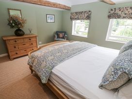 A bedroom with a bed and dresser at Syleham House Syleham near Eye