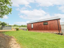 An outdoor view of a cabin with a hot tub at Mallard Lodge in Moscow near Galston