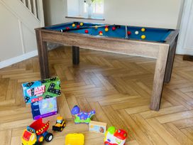 A pool table with colorful balls in a game room at Rhos Las in Cerrigydrudion