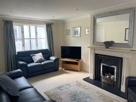 A living room with a television and sofa at 3 Strawberry Close Little Haven near Broad Haven