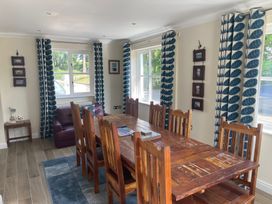 A dining room with a wooden table and chairs at 3 Strawberry Close Little Haven near Broad Haven
