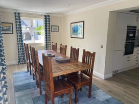 A dining room with a table and chairs at 3 Strawberry Close Little Haven near Broad Haven