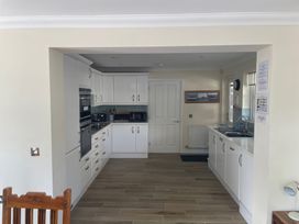 A kitchen with cabinets and appliances at 3 Strawberry Close Little Haven near Broad Haven