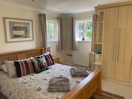 A bedroom with a bed and wardrobe at 3 Strawberry Close Little Haven near Broad Haven