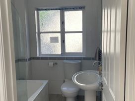 A bathroom with a toilet, sink, and bathtub at 3 Strawberry Close Little Haven near Broad Haven