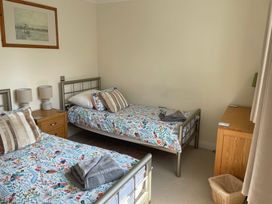 A bedroom with two single beds and bedside tables at 3 Strawberry Close Little Haven near Broad Haven