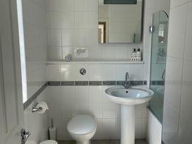 A bathroom with a sink, toilet, and shower at 3 Strawberry Close Little Haven near Broad Haven