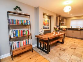 A dining room with a table and bookshelf at The Beach Retreat in The Bay - Filey