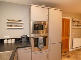 A kitchen with an oven and microwave at The Beach Retreat in The Bay - Filey