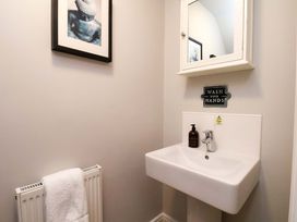 A bathroom with a sink and mirror at The Beach Retreat The Bay - Filey